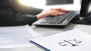 attorney typing on laptop